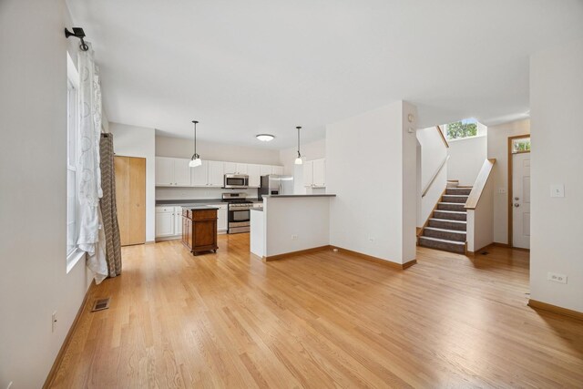 18582 W Point Dr, Tinley Park, IL 60477 - unfurnished living room with light wood finished floors, stairway, and baseboards