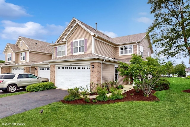 367 Mcgrath Dr, Oswego, IL 60543 - view of front of house with an attached garage, driveway, a front lawn, brick siding, and a shingled roof