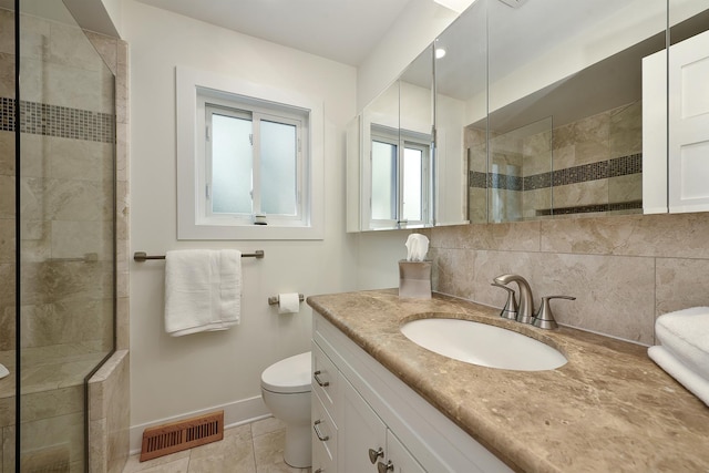 1605 E Euclid Ave, Arlington Heights, IL 60004 - bathroom featuring toilet, baseboards, a tile shower, vanity, and tile patterned flooring