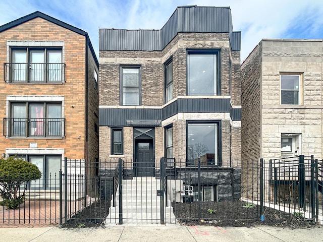 3926 W Arthington St, Chicago, IL 60624 - view of front of house with a fenced front yard and brick siding