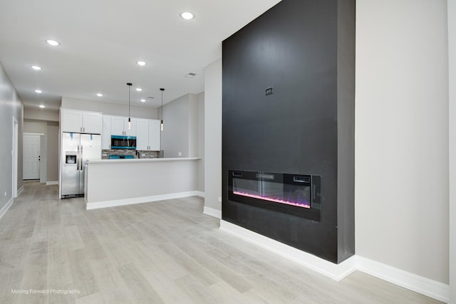 3926 W Arthington St, Chicago, IL 60624 - kitchen featuring appliances with stainless steel finishes, recessed lighting, light wood-type flooring, white cabinetry, and baseboards