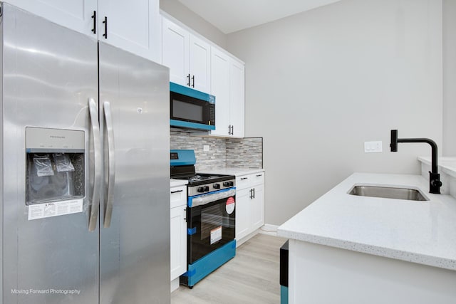 3926 W Arthington St, Chicago, IL 60624 - kitchen featuring stainless steel refrigerator with ice dispenser, electric stove, a sink, decorative backsplash, and light wood-style floors