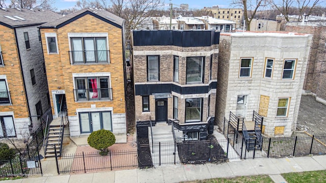 3926 W Arthington St, Chicago, IL 60624 - view of front facade with a fenced front yard and brick siding