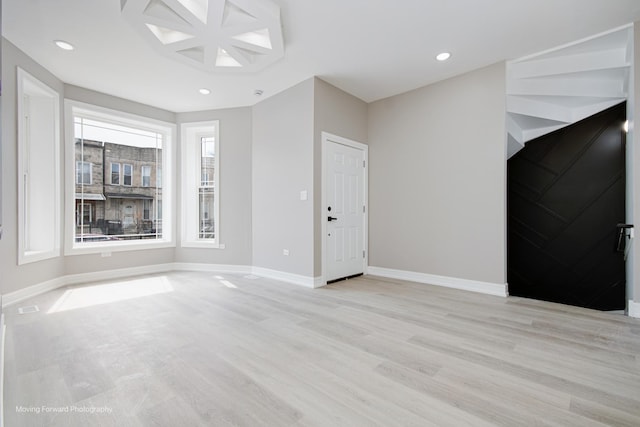 3926 W Arthington St, Chicago, IL 60624 - unfurnished living room with light wood-type flooring, baseboards, and recessed lighting