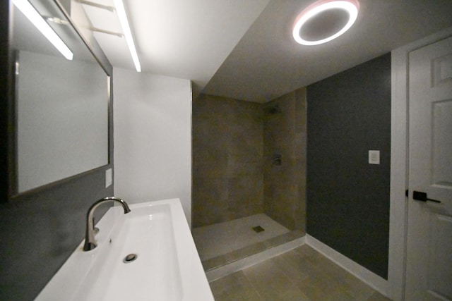 7832 S Evans Ave, Chicago, IL 60619 - full bathroom with tiled shower, a sink, baseboards, and tile patterned floors
