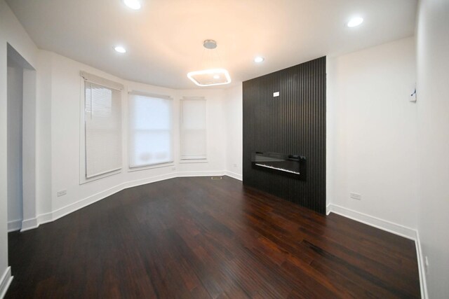 7832 S Evans Ave, Chicago, IL 60619 - unfurnished room with dark wood-style floors, baseboards, recessed lighting, and a glass covered fireplace