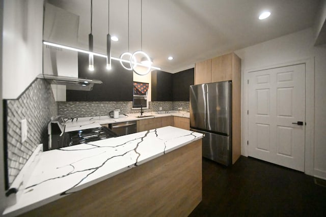 7832 S Evans Ave, Chicago, IL 60619 - kitchen featuring appliances with stainless steel finishes, a peninsula, light stone counters, wall chimney exhaust hood, and a sink