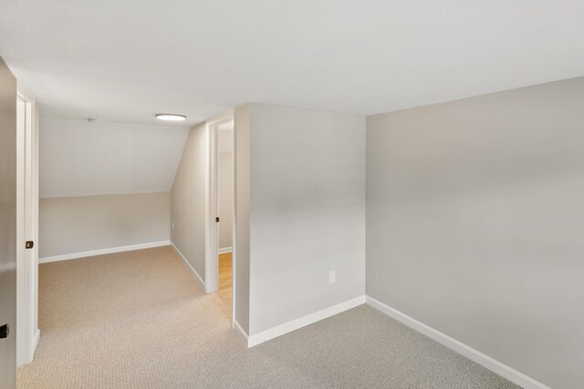 3413 N Schultz Dr, Lansing, IL 60438 - additional living space with light carpet, baseboards, and lofted ceiling