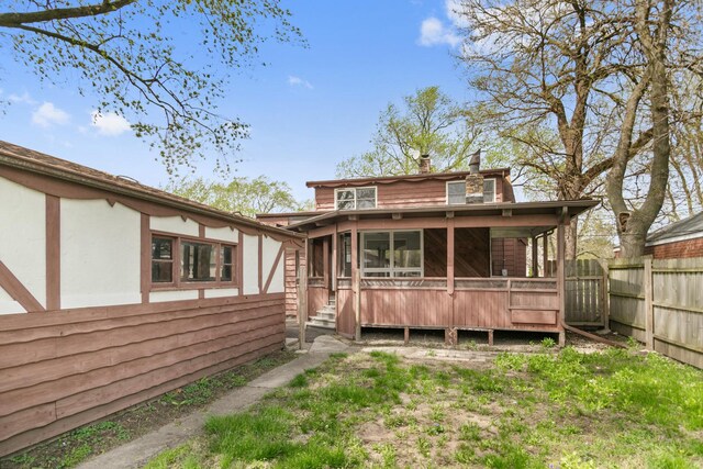 3413 N Schultz Dr, Lansing, IL 60438 - rear view of house featuring a sunroom and a chimney