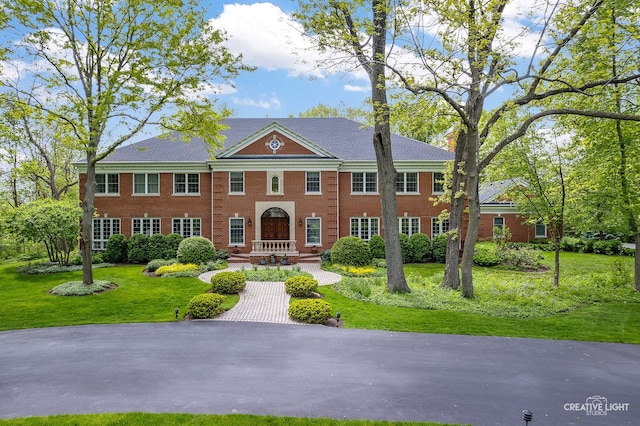 1900 Millburne Rd, Lake Forest, IL 60045 - georgian-style home with a front lawn and brick siding