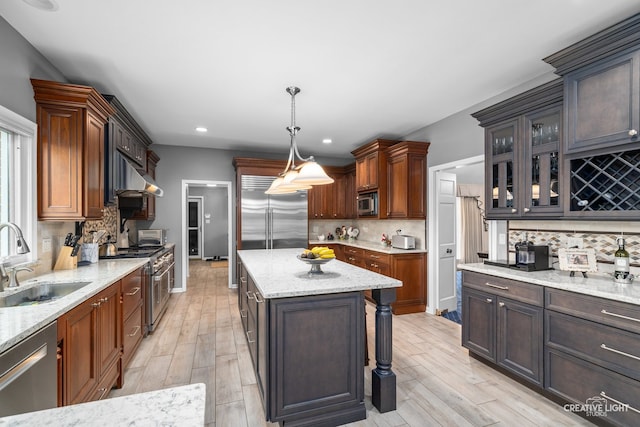 1900 Millburne Rd, Lake Forest, IL 60045 - kitchen with built in appliances, a sink, backsplash, glass insert cabinets, and light stone counters