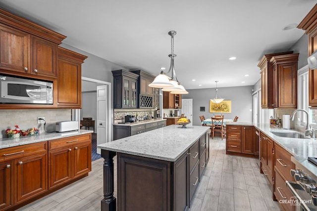 1900 Millburne Rd, Lake Forest, IL 60045 - kitchen featuring stainless steel microwave, a sink, decorative backsplash, light stone counters, and recessed lighting