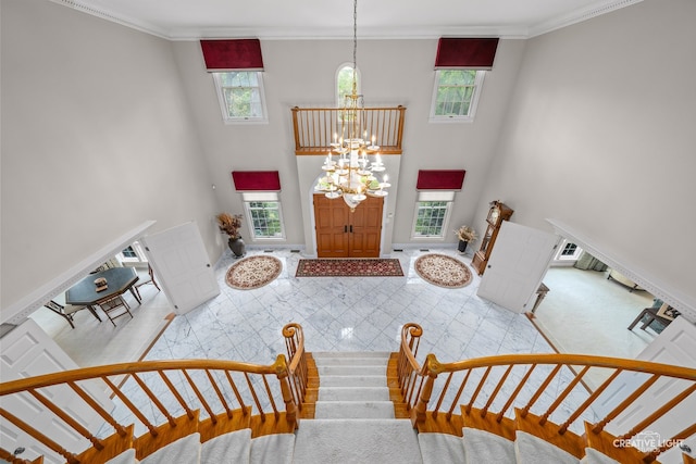 1900 Millburne Rd, Lake Forest, IL 60045 - foyer with a chandelier, healthy amount of natural light, a towering ceiling, and ornamental molding