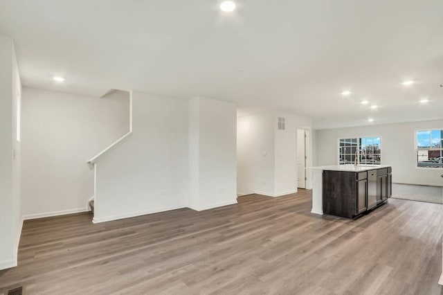 358 Bridgeview Ct, Saint Charles, IL 60174 - unfurnished living room featuring light wood-style flooring, baseboards, recessed lighting, and stairway