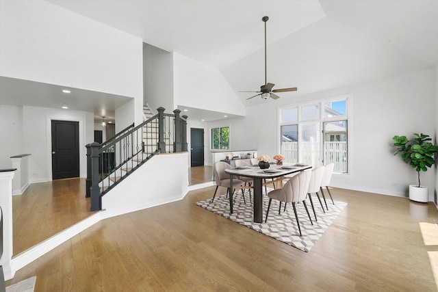 19325 Kickapoo Dr, Tinley Park, IL 60487 - dining area featuring ceiling fan, stairs, wood finished floors, high vaulted ceiling, and baseboards