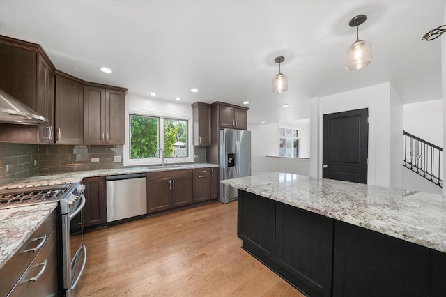 19325 Kickapoo Dr, Tinley Park, IL 60487 - kitchen featuring stainless steel appliances, light wood-type flooring, hanging light fixtures, a sink, and tasteful backsplash