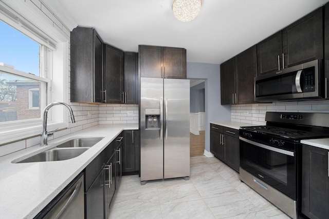 9632 S Yale Ave, Chicago, IL 60628 - kitchen with appliances with stainless steel finishes, a sink, tasteful backsplash, and light marble finish floors