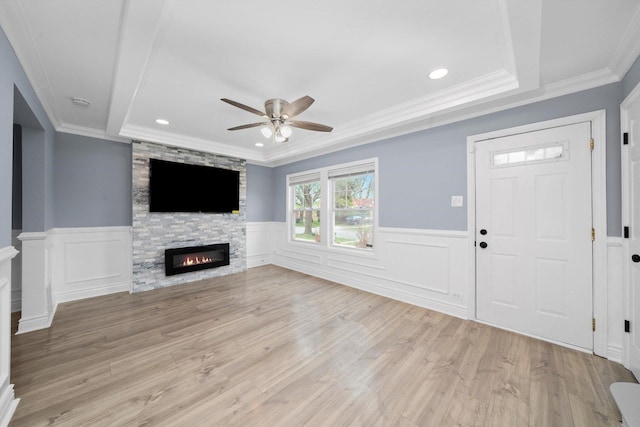 9632 S Yale Ave, Chicago, IL 60628 - unfurnished living room featuring a ceiling fan, light wood finished floors, recessed lighting, a wainscoted wall, and a stone fireplace