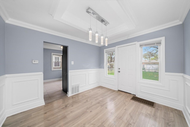 9632 S Yale Ave, Chicago, IL 60628 - entrance foyer with a wainscoted wall, light wood-style flooring, crown molding, a raised ceiling, and a decorative wall