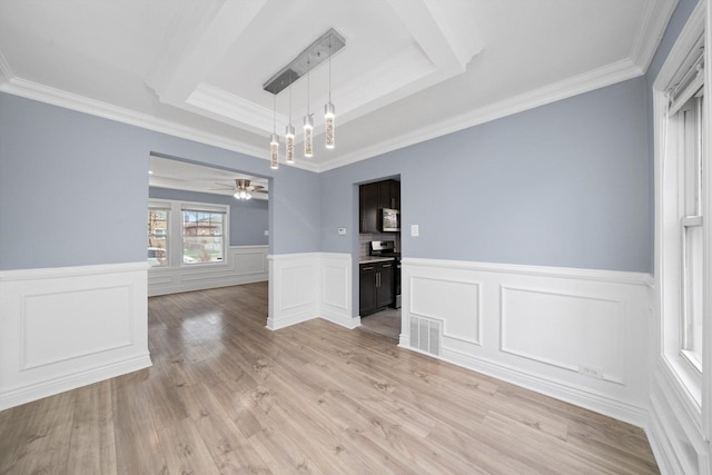 9632 S Yale Ave, Chicago, IL 60628 - unfurnished dining area featuring a tray ceiling, ornamental molding, a ceiling fan, a wainscoted wall, and light wood-style flooring