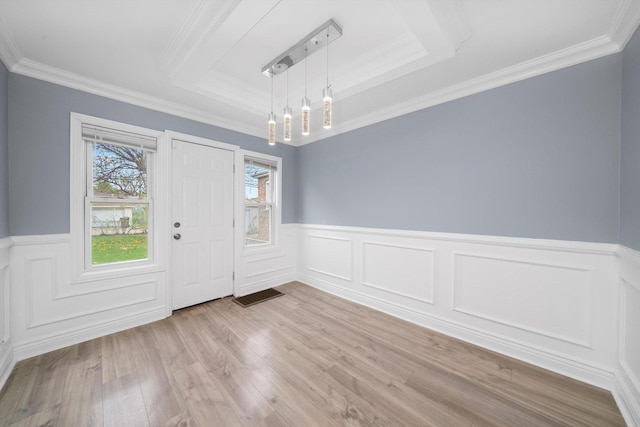 9632 S Yale Ave, Chicago, IL 60628 - unfurnished dining area featuring a tray ceiling, wainscoting, light wood finished floors, crown molding, and a chandelier