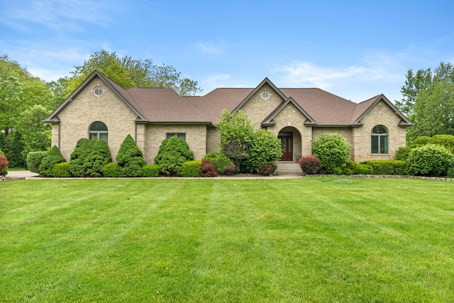 8600 Beall St, Dyer, IN 46311 - french country home featuring a front lawn, brick siding, and roof with shingles