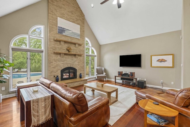 8600 Beall St, Dyer, IN 46311 - living area featuring high vaulted ceiling, wood finished floors, a ceiling fan, a fireplace, and baseboards