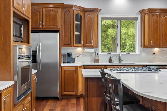 8600 Beall St, Dyer, IN 46311 - kitchen featuring stainless steel appliances, a sink, glass insert cabinets, dark wood-style flooring, and healthy amount of natural light