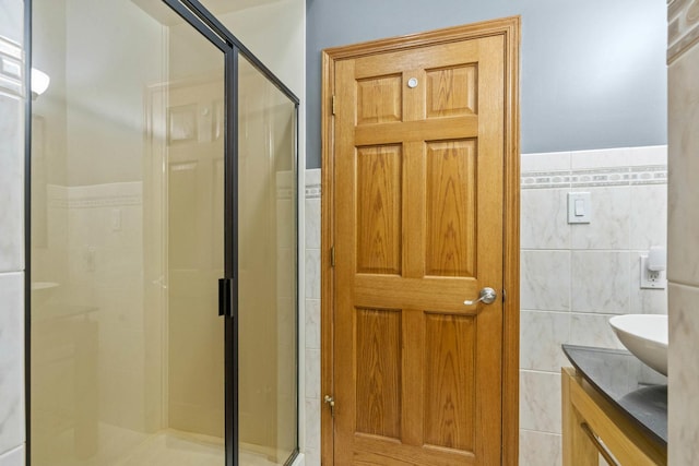 8600 Beall St, Dyer, IN 46311 - bathroom featuring tile walls, a shower stall, double vanity, and wainscoting