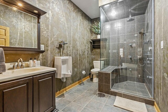 8600 Beall St, Dyer, IN 46311 - full bath featuring toilet, a shower stall, vanity, tile patterned flooring, and baseboards
