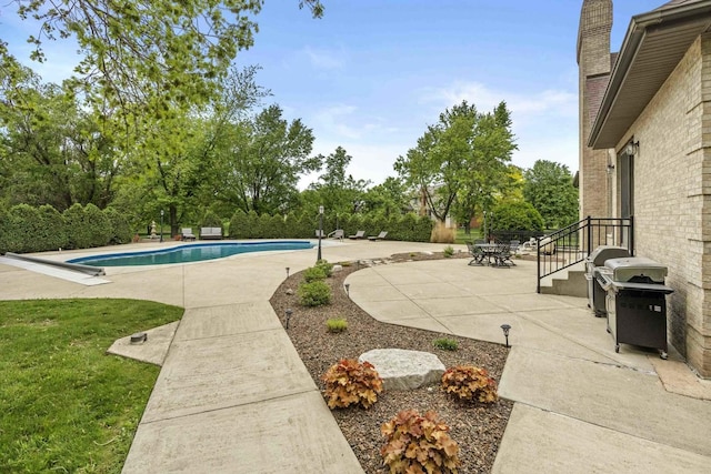 8600 Beall St, Dyer, IN 46311 - swimming pool featuring a patio, a grill, and view of wooded area