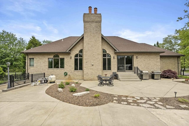 8600 Beall St, Dyer, IN 46311 - rear view of property with a chimney, a patio area, brick siding, roof with shingles, and entry steps
