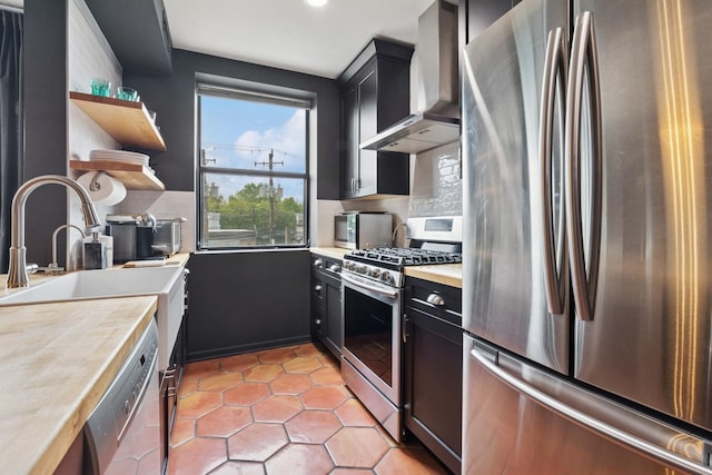 5730 N Hermitage Ave Unit 2, Chicago, IL 60660 - kitchen with stainless steel appliances, wall chimney range hood, open shelves, tasteful backsplash, and light countertops