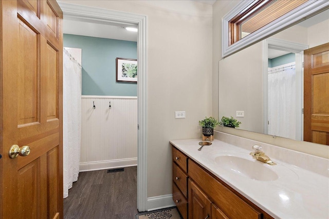27425 S Steven Ray Dr, Monee, IL 60449 - full bathroom featuring vanity, wood finished floors, a wainscoted wall, and curtained shower