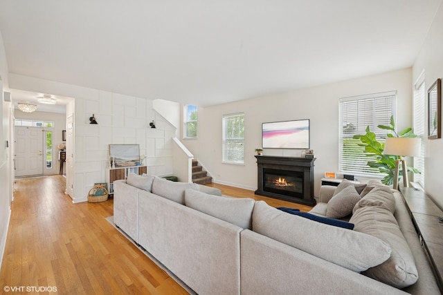2363 Trailside Ln, Wauconda, IL 60084 - living area with light wood-style flooring, a glass covered fireplace, and healthy amount of natural light