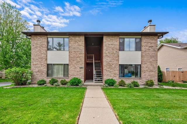 11405 Douglas Ave Unit D, Huntley, IL 60142 - view of front of home with a chimney, brick siding, and stairway