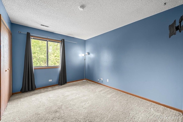 11405 Douglas Ave Unit D, Huntley, IL 60142 - unfurnished room featuring carpet, baseboards, and a textured ceiling