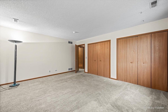 11405 Douglas Ave Unit D, Huntley, IL 60142 - unfurnished bedroom with carpet, multiple closets, a textured ceiling, and baseboards