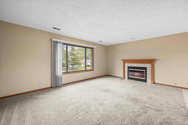 11405 Douglas Ave Unit D, Huntley, IL 60142 - unfurnished living room with carpet, a brick fireplace, baseboards, and a textured ceiling
