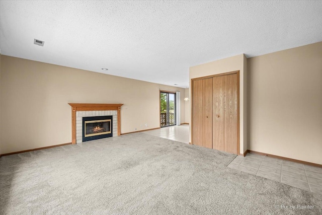 11405 Douglas Ave Unit D, Huntley, IL 60142 - unfurnished living room with light carpet, a fireplace, a textured ceiling, and baseboards
