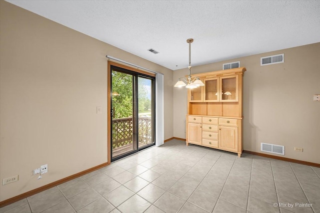 11405 Douglas Ave Unit D, Huntley, IL 60142 - unfurnished dining area with baseboards, a textured ceiling, and light tile patterned floors