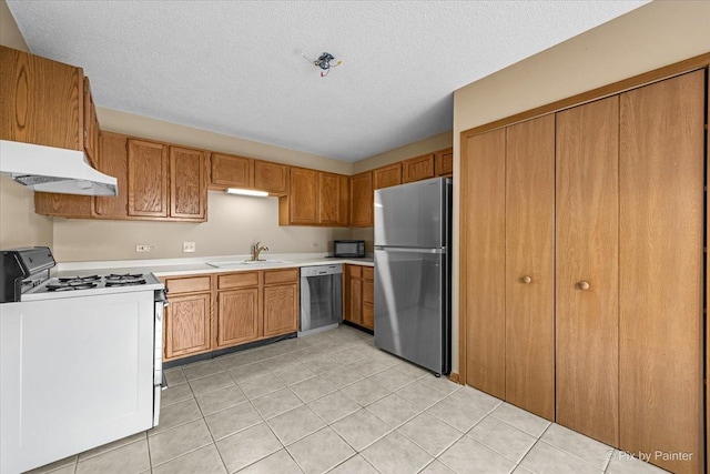11405 Douglas Ave Unit D, Huntley, IL 60142 - kitchen with stainless steel appliances, under cabinet range hood, a sink, light countertops, and brown cabinets