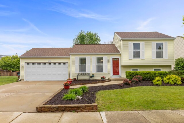 1191 Narragansett Dr, Carol Stream, IL 60188 - split level home with an attached garage, driveway, a front lawn, and roof with shingles