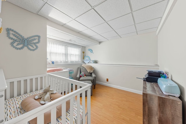 1191 Narragansett Dr, Carol Stream, IL 60188 - bedroom with wood finished floors, a paneled ceiling, baseboards, and a crib