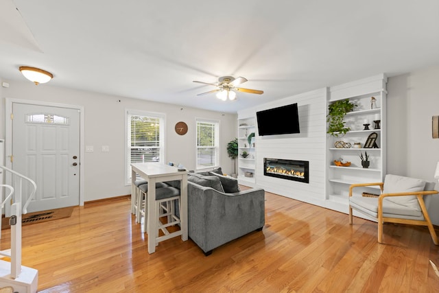 1191 Narragansett Dr, Carol Stream, IL 60188 - living area with light wood-type flooring, a fireplace, a ceiling fan, and built in features