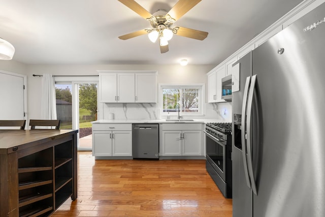 1191 Narragansett Dr, Carol Stream, IL 60188 - kitchen featuring stainless steel appliances, a sink, white cabinets, and light countertops