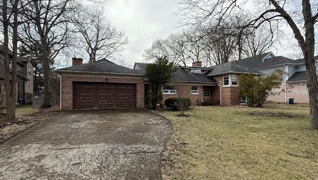 1850 Garland Ave, Highland Park, IL 60035 - view of front of house featuring asphalt driveway, a garage, a chimney, and a front lawn