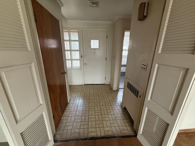1850 Garland Ave, Highland Park, IL 60035 - entryway featuring brick patterned flooring, baseboards, healthy amount of natural light, and ornamental molding