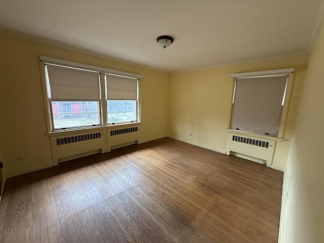 1850 Garland Ave, Highland Park, IL 60035 - spare room featuring radiator, wood finished floors, and ornamental molding