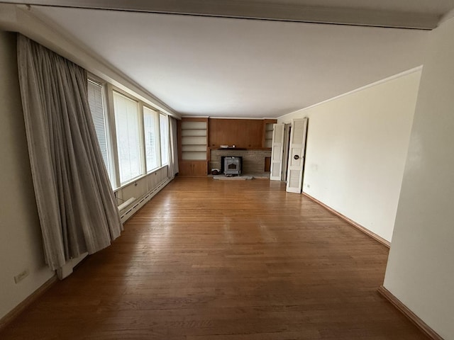 1850 Garland Ave, Highland Park, IL 60035 - unfurnished living room with baseboard heating, wood finished floors, baseboards, and a wood stove